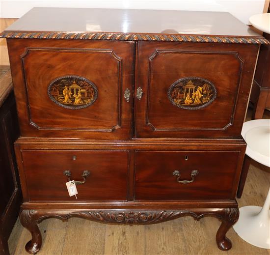 A carved side cabinet with ropetwist-moulded top over a pair of doors with oval Chinoiserie panels and two deep drawers W.92cm